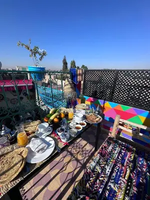 a table full of food and drinks on a balcony at Riad Eva in Marrakech