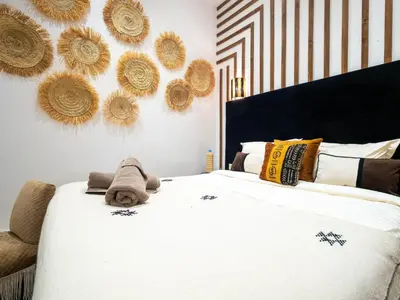 a bedroom with a bed with a teddy bear on it at Riad La Croix Berbere Deluxe in Marrakech