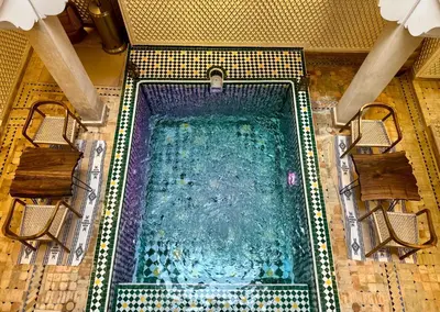 an overhead view of a swimming pool with chairs at Riad La Croix Berbere Deluxe in Marrakech