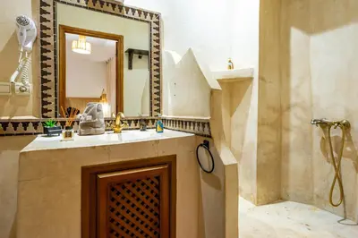 a bathroom with a sink and a mirror at Riad La Croix Berbere Deluxe in Marrakech