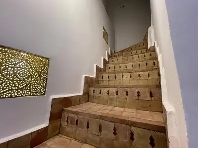 a set of stairs in a house with a painting at RIAD ZEFYR in Marrakech