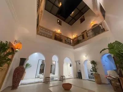a large room with white walls and arched ceilings at RIAD ZEFYR in Marrakech
