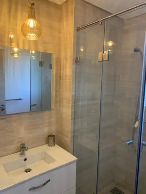 a bathroom with a sink and a glass shower at Marrakech Prestigia Jade Golf Piscine in Marrakech