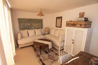 a living room with a couch and a chair at Riad Dar Jabel in Marrakech