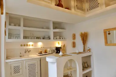 a kitchen with white cabinets and a counter top at Riad Dar Jabel in Marrakech