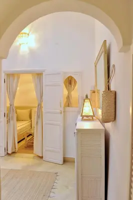 a room with an archway with a bed and a table at Riad Dar Jabel in Marrakech