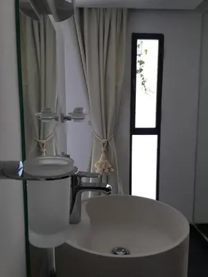 a bathroom with a white sink and a window at Riad Love B&B in Marrakech