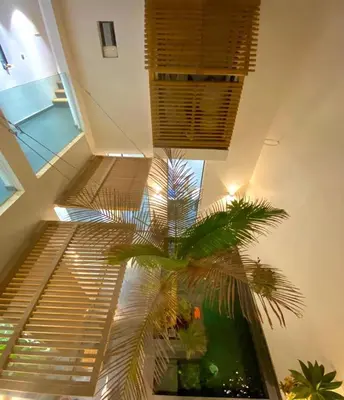 a staircase with a palm tree in a building at Riad Love B&B in Marrakech