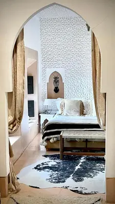 a bedroom with a bed with an archway in it at Riad Chocolat in Marrakech