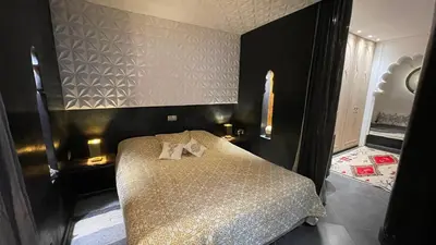 a bedroom with a bed with two towels on it at Riad Chocolat in Marrakech