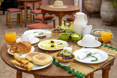 a table filled with breakfast foods and orange juice at Riad Dabachi in Marrakech