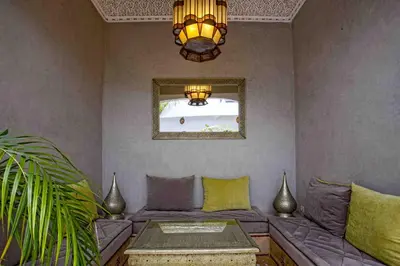 a living room with a couch and a chandelier at Riad Dabachi in Marrakech