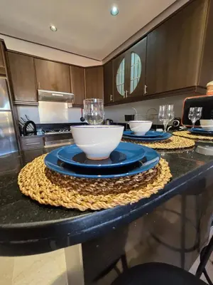 a kitchen with a table with bowls and glasses on it at Cosy Bagatelle Houses 1 & 2 in Marrakech