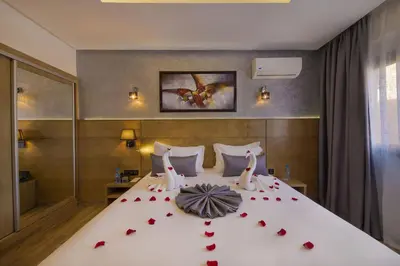 a bedroom with a bed with red roses on it at Stars Hotel & Spa in Marrakech