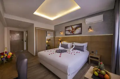 a hotel room with a large bed with flowers on it at Stars Hotel & Spa in Marrakech