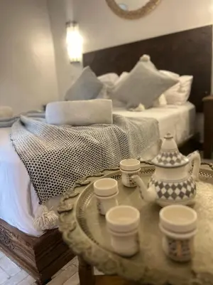 a room with a bed and a table with a tea set at Casa De Marrakech Riad Guest House in Marrakech