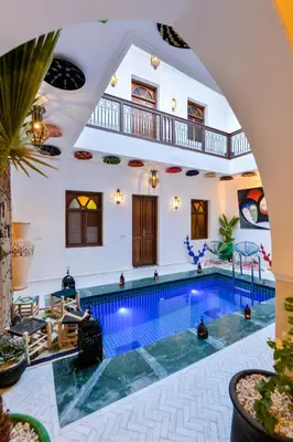 an indoor pool in a house with an arched ceiling at Casa De Marrakech Riad Guest House in Marrakech