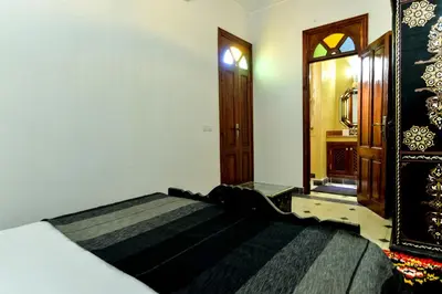 a bedroom with a large bed in a room at Casa De Marrakech Riad Guest House in Marrakech