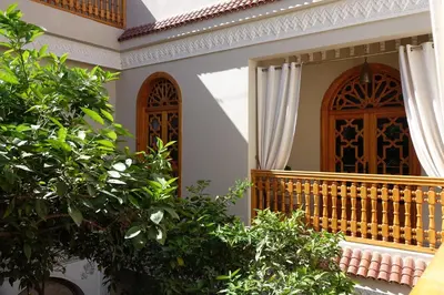a front porch of a house with a wooden door at RIAD SHAJARA in Marrakech