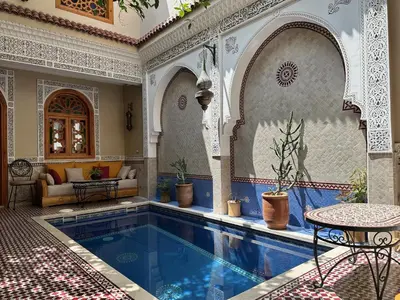 a swimming pool in a room with a house at RIAD SHAJARA in Marrakech