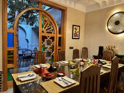 a dining room with a table in a restaurant at RIAD SHAJARA in Marrakech