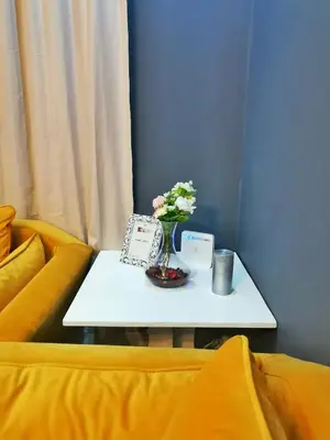 a table with a vase of flowers on top of a couch at La saphir marrakech in Marrakech
