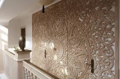 a wall with a wooden design on it at Riad Wazani Square & SPA in Marrakech