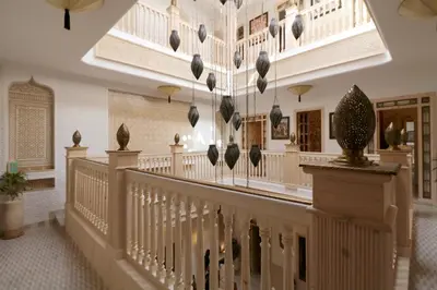 a staircase in a building with art on the walls at Riad Wazani Square & SPA in Marrakech