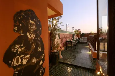 a painting of a woman on the side of a building at Riad Wazani Square & SPA in Marrakech
