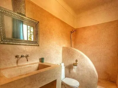 a bathroom with a sink and a toilet and a mirror at Dar 14 Marrakech in Marrakech