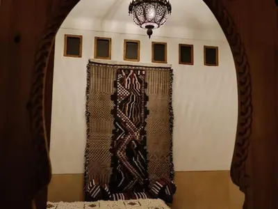 a room with a window with a curtain and a chandelier at Dar 14 Marrakech in Marrakech