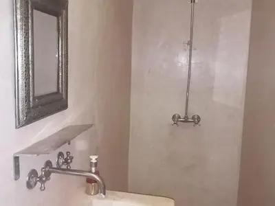 a bathroom with a sink and a mirror at Dar 14 Marrakech in Marrakech