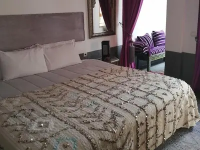 a bedroom with a large bed with a blanket on it at Dar 14 Marrakech in Marrakech