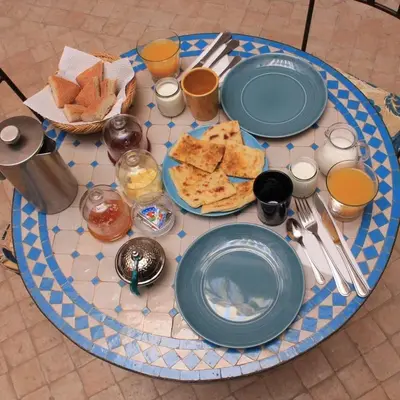 a table with plates of food on top of it at Dar 14 Marrakech in Marrakech