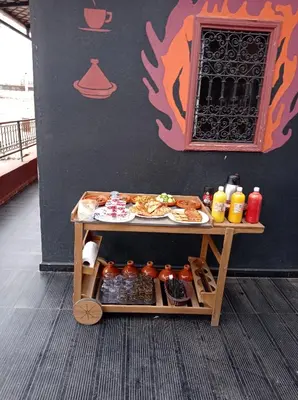 a table with plates of food and drinks on it at Stork Marrakech Luxury Hostel in Marrakech