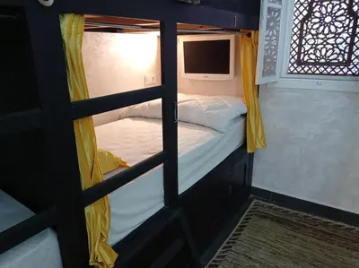 a couple of bunk beds in a room with a window at Stork Marrakech Luxury Hostel in Marrakech