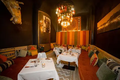 a dining room with white tables and a chandelier at MAISON MK Adults ONLY - Music Riad in Marrakech
