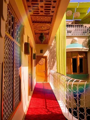 a hallway with a red carpet and a yellow door at MAISON MK Adults ONLY - Music Riad in Marrakech
