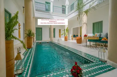 a swimming pool in a hotel with christmas decorations at RIAD RIME QOUSSAI in Marrakech