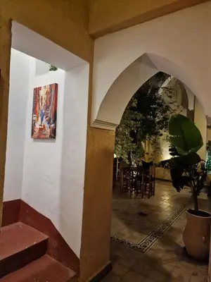 an archway in a building with a painting on the wall at Hostel Laksour in Marrakech