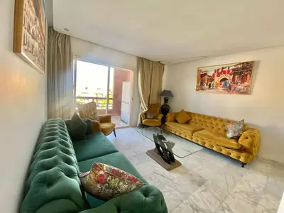 a living room with a yellow couch and a green couch at RIAD GARDEN LUXURY AGDAL in Marrakech