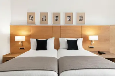 a hotel room with two beds and two lamps at Hotel Riu Tikida Garden - Adults Only - All Inclusive in Marrakech