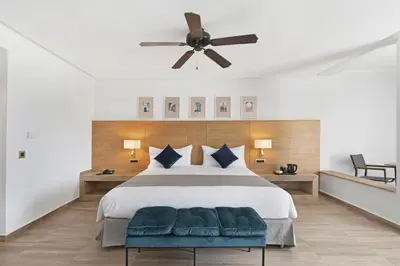 a bedroom with a bed and a ceiling fan at Hotel Riu Tikida Garden - Adults Only - All Inclusive in Marrakech