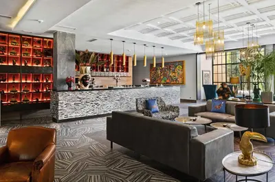 a lobby of a hotel with couches and a bar at Hotel Riu Tikida Garden - Adults Only - All Inclusive in Marrakech