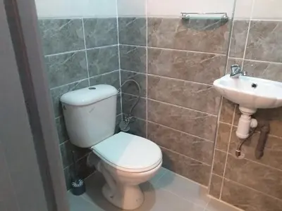 a bathroom with a toilet and a sink at studio Dar Rmila in Marrakech
