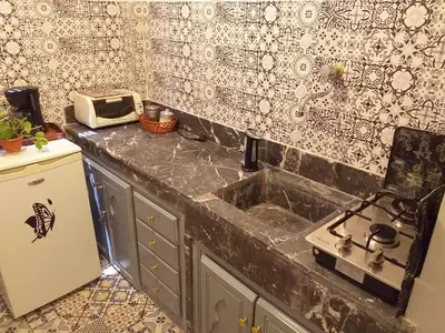 a kitchen with a sink and a toaster oven at studio Dar Rmila in Marrakech