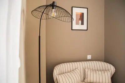 a floor lamp in a living room with a couch at Le Pavillon de la Kasbah & SPA Marrakech in Marrakech