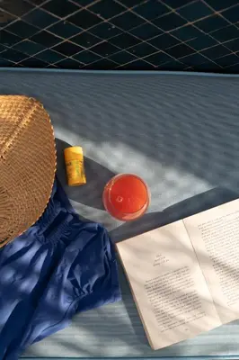 a hat and a piece of paper on a table at Le Pavillon de la Kasbah & SPA Marrakech in Marrakech