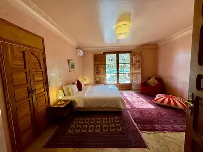 a bedroom with a bed and a window and a door at Villa Ross in Marrakech