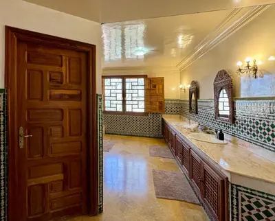 a bathroom with a double sink and a wooden door at Villa Ross in Marrakech